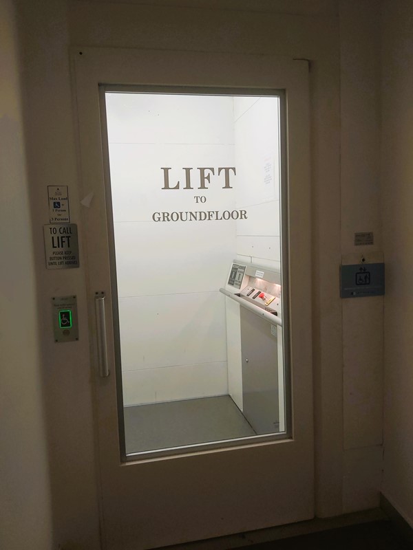 Image of a glass door with a sign on it