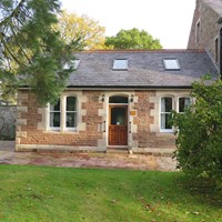 Front view Of Holly Lodge The level entrance is to the rear