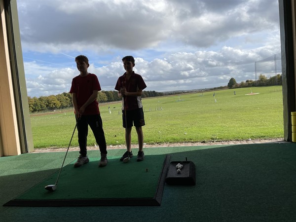 Image of two people playing gold
