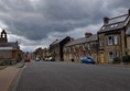 Alnwick Youth Hostel (takes up most of the buildings on the right) with blue badge street parking on the left