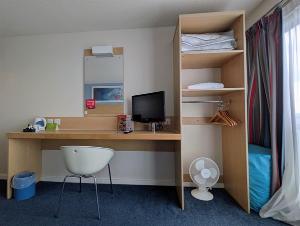 Image of desk and clothing storage