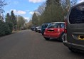Image of where we parked the car, all cars are lined up side by side at the right-hand side of the image.