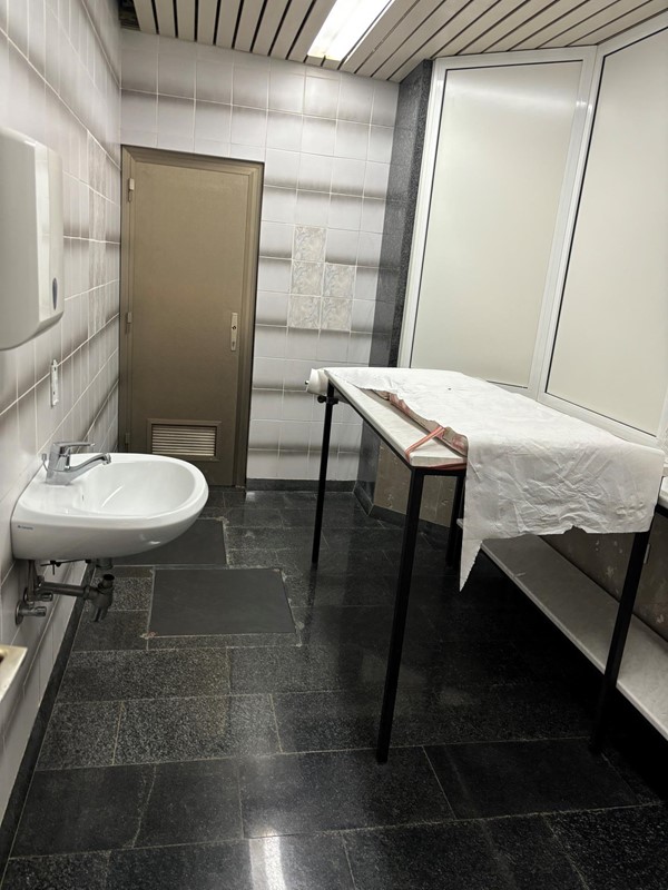 Image of a bathroom with a table and sink
