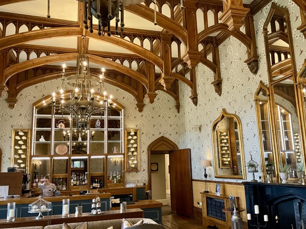“THE OAK ROOM” One of the three original lounges of the old castle, beautifully restored, in this old Victorian mansion. It still has its historical charm, now mixed with modern facilities. This is one of the popular rooms of the old part of the castle, with its delightful wooden beams, picture frames of golden furnished frames. The cups on display add a real charm to the room. It’s a pleasant place to relax in, the drinks are very well made, and of course it’s here you enjoy any afternoon tea you have pre-booked. The chairs are reasonably comfortable, and the view through the windows towards the grounds offer the charm of the fresh green grass and shrubbery that helps the body and mind to unwind.