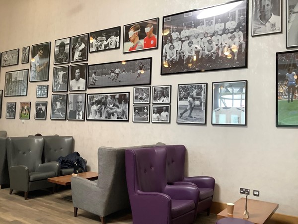 Picture of the seating area with football pictures on the wall