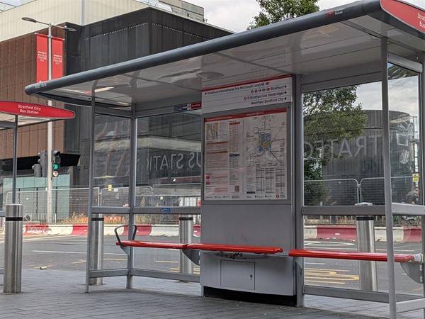 Image of covered bus shelter with perching benches