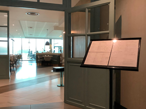 Entrance to hotel dining room showing the menu on a stand outside the door