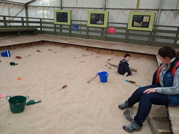 Pretending to be an archaeologist, but bones to find in the sand