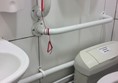 Red emergency cord tied up out of reach of anyone who falls to the floor and gets injured.
