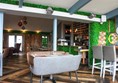 Inside the restaurant with different types of tables.
