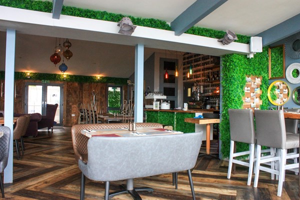 Inside the restaurant with different types of tables.