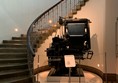 One of the staircases in the museum and an old printing press on display at the foot of the stairs