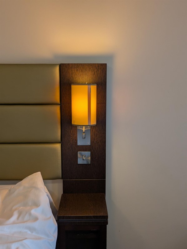 Image of tables on either side of the the bed