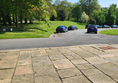 Image of a road with cars parked on it