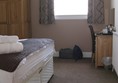Picture of Grammer Lodge - Room, full tea making. Note high ceiling. Bed height was challenging for wheelchair transfer.