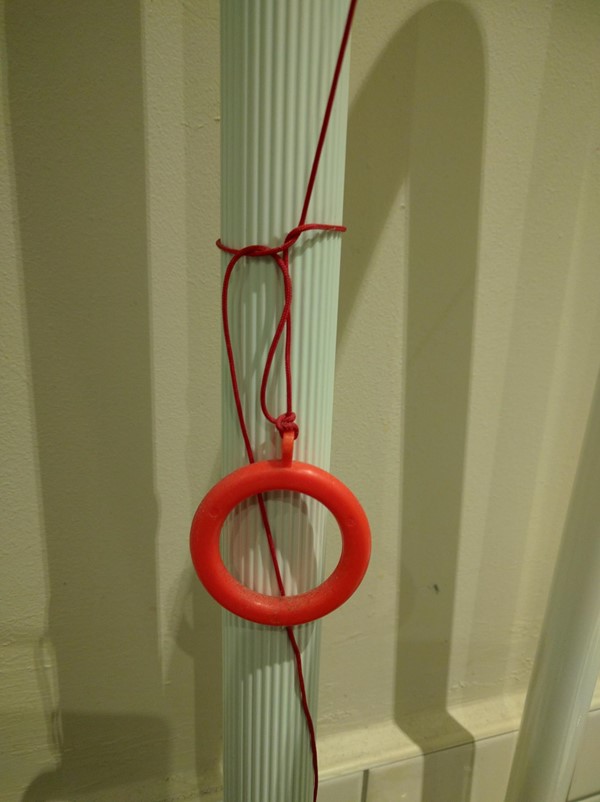 Picture of EAT, One New Change - Red Cord tied up out of reach around a grabrail.