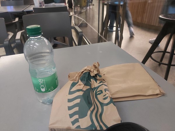 Picture of a Starbucks bag and an empty plastic bottle