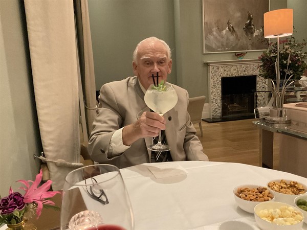 Image of a person with a drink at a table