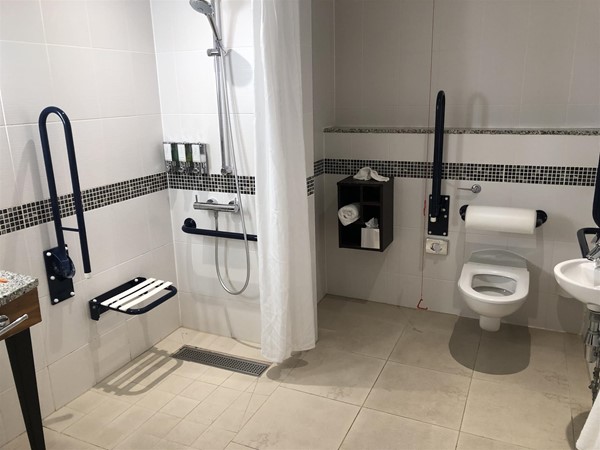 A good sized wetroom with wall mounted seat