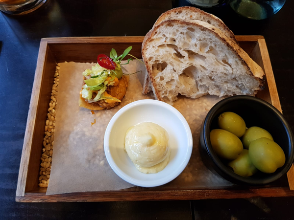 Pork cheek taco with green olives, sourdough and chicken fat butter