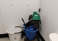 Image of cleaning equipment left inside the toilet room that is easily reached by children etc.