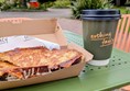 Image of a cheese toastie and a hot drink on a table