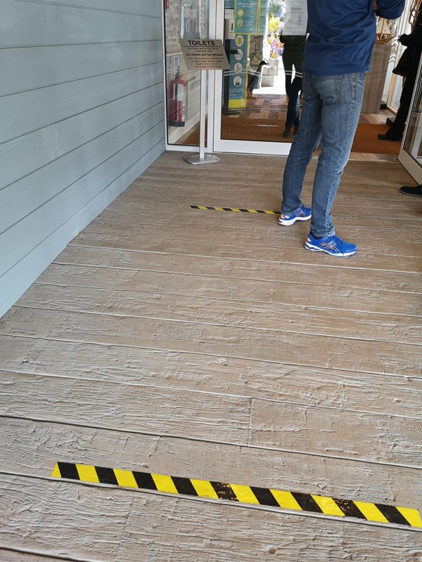 Entrance to the restaurant with tape to ensure social distancing.