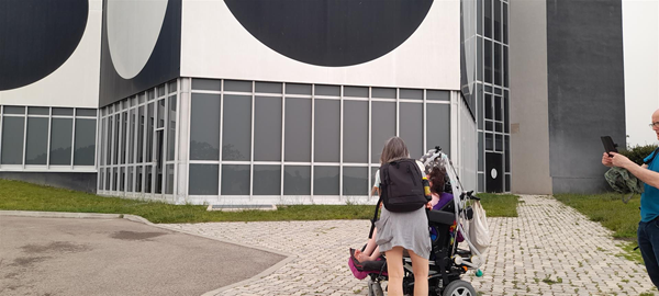 Image of two people heading towards a building