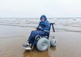 A person in a wheelchair on a beach