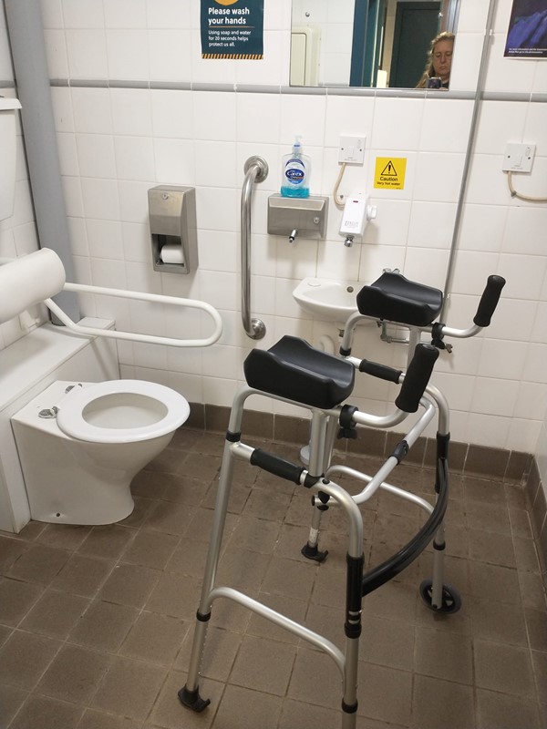 Accessibility toilet showing the size of the area and that there is only one grab bar on the left - none on the right.