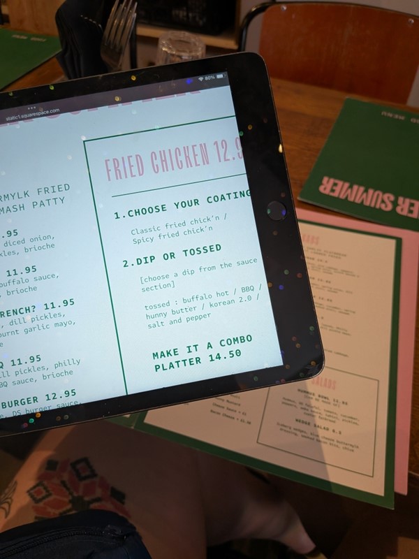 image of menu on paper and on tablet