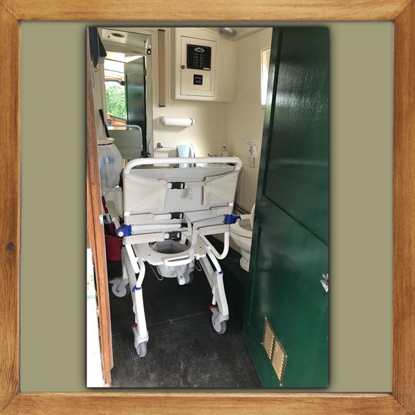 Toilet with chair besides it