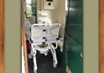 Toilet with chair besides it