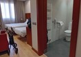 Image of a bathroom with a stroller and beds