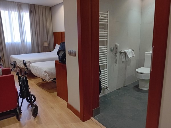 Image of a bathroom with a stroller and beds
