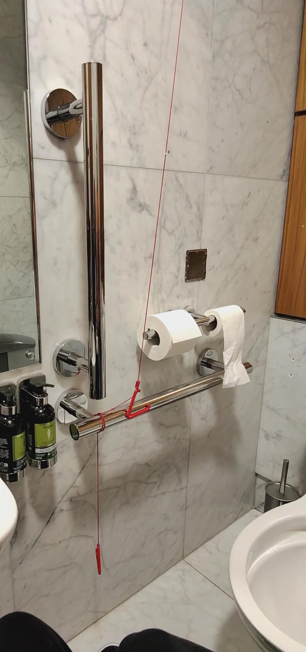 Image of a red cord tied around a grab rail