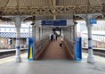 The steep pedestrian ramp from the platforms to the footbridge.