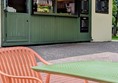 Image of kiosk with table and chair in front of it