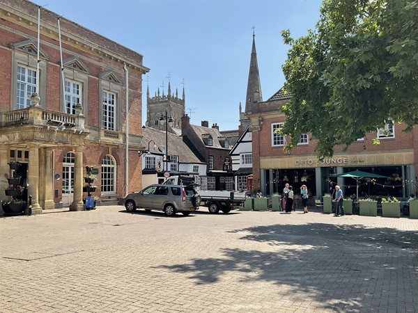 Image of buildings with a church spire in the background
