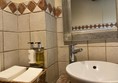 Image of a sink, soap and paper towels