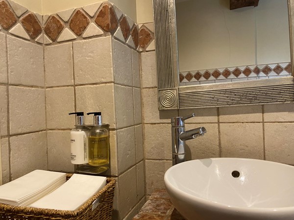 Image of a sink, soap and paper towels