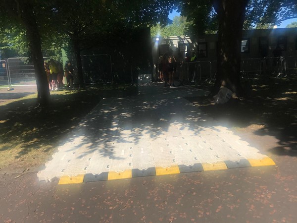 Image of the accessible booking office and a mat over the grass area.