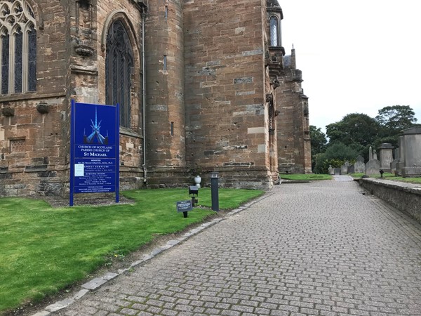 Heading towards the wheelchair accessible entrance over flat cobbles.