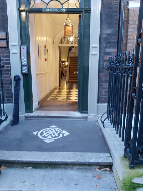Entrance with shallow steps and railings both side, which could be used as hand rails