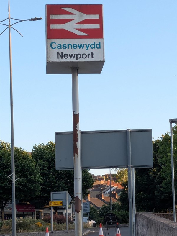 Image of a pole with signage for Newport Station