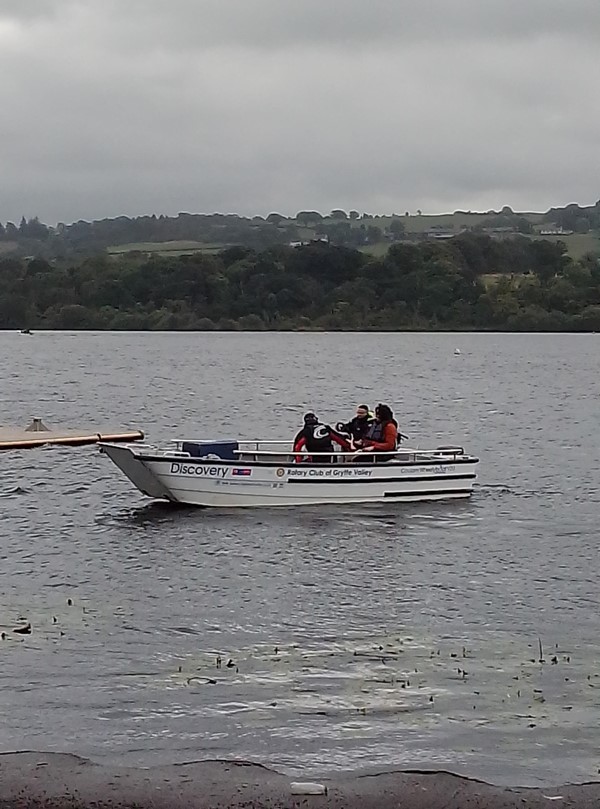 Image of a group of people in a boat on a lake