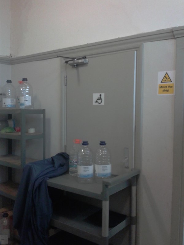 Trolley blocking entrance to accessible toilet