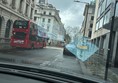 Image of a bus going down a road through a window