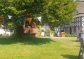 Lawn, tree with bunting and Little Moreton Hall in the background