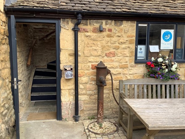 Water pump by a door with some stairs